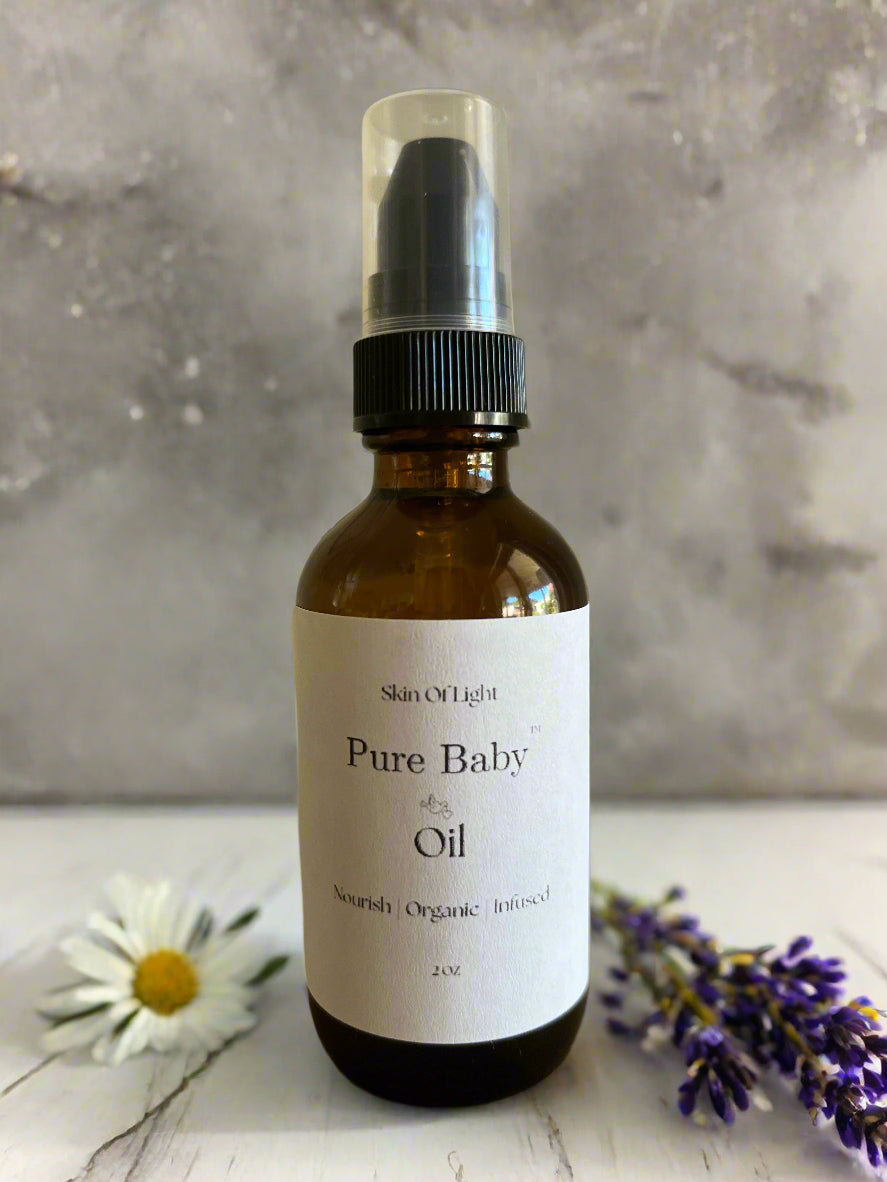 Bottle of Pure Baby Oil with a white label on a wooden surface