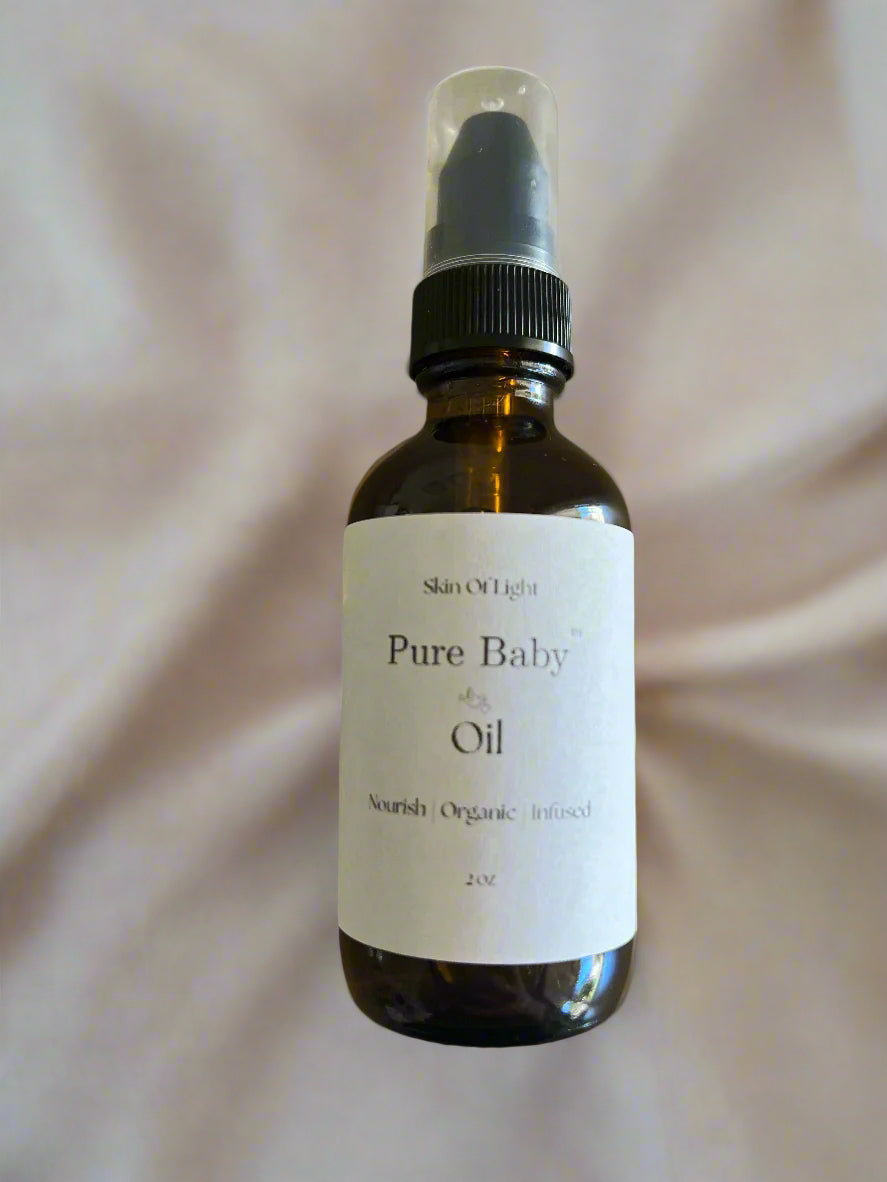 Bottle of 'Pure Baby Oil' by Skin of Light on a beige background